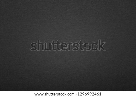 Black paper texture or background with vignette. Blank black page with vignette.