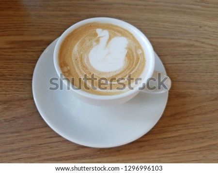 Latte art swan, coffee cup in a cafe concept.