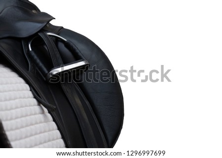 Riding saddle in close-up with stirrup inserted
