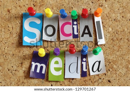 Social media from cutout newspaper headlines pinned to a cork bulletin board Royalty-Free Stock Photo #129701267