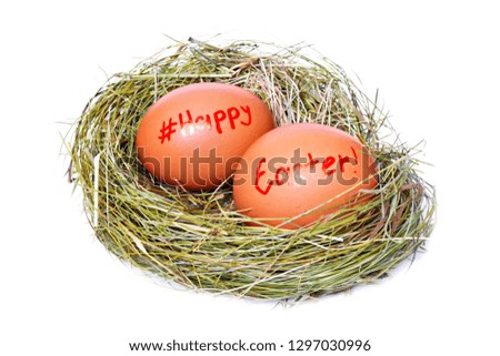 Two brown chicken eggs in straw nest with red color text happy Easter and sign hashtag for social network on white background. Isolated
