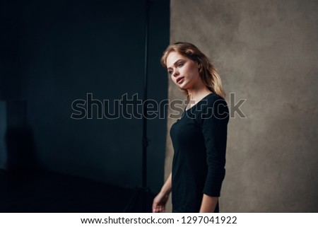 Beautiful woman in a black dress at a photo shoot Paparazzi