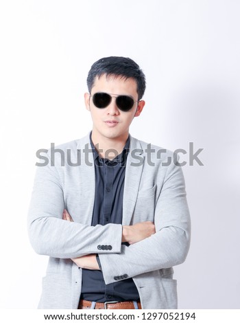 A Portrait of young asian man in casual business clothes  and showing gesture sign