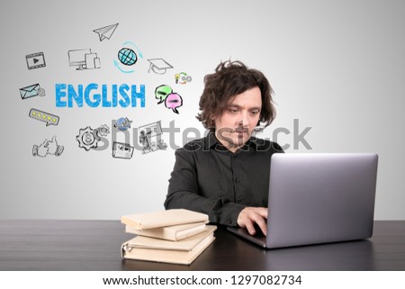 English, knowledge and learning online concept. Businessman working on laptop at office. Gray background with icons