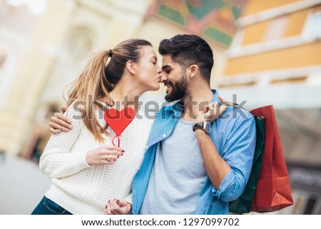 Happy couple shopping together for Valetine's day and having fun. Royalty-Free Stock Photo #1297099702