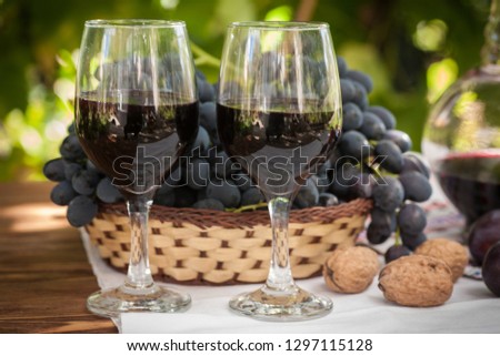 Wine in glasses with bunch of grape.