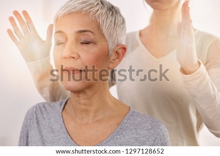 Woman having reiki healing treatment , alternative medicine concept, holistic care Royalty-Free Stock Photo #1297128652