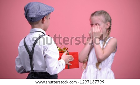Gallant boy surprising his little girlfriend with present, birthday celebration