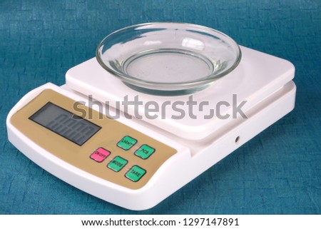Electronic compact scale or small digital weight scales, Weighing the glass jar with clipping path. 
