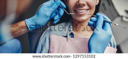 Attractive young woman in stomatology clinic with male dentist. Healthy teeth concept. Royalty-Free Stock Photo #1297153102