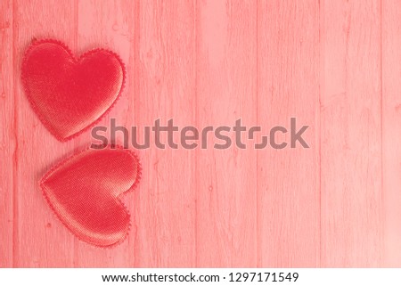 Pastel pink image of two valentine hearts on a wooden plank background. Concept love, Valentine's day. Flat lay, top view, copy space.