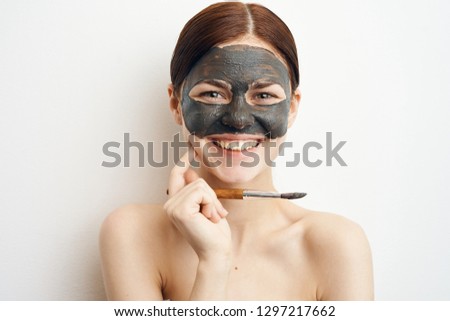 beauty woman in a cosmetic mask of clay smiling portrait