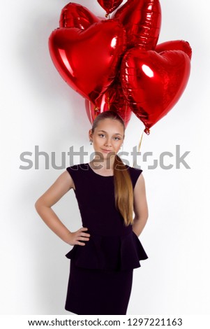 Valentine Beauty young girl, teenager with red air balloon portrait, isolated on background. Beautiful Happy Young kid holding balloons. Holiday party, birthday. Joyful little model - Image