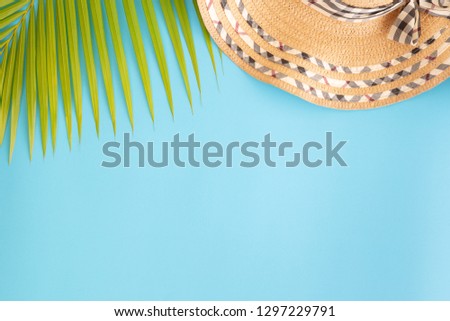 Flat lay photo coconut leaf and hat on blue background , top view and copy space for montage your product	