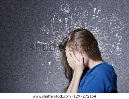 Sad young man with worried stressed face expression and brain melting into lines question marks. Obsessive compulsive, adhd, anxiety disorders concept Royalty-Free Stock Photo #1297272154