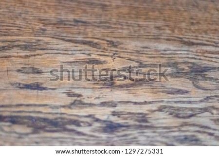 Texture of old wooden table top closeup, taupe color. Soft focus with shallow depth of field.