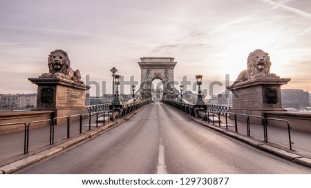 Magnificent Chain Bridge in beautiful Budapest. Szechenyi Lanchid is a suspension bridge that spans the River Danube between Buda and Pest, in the capital of Hungary. Royalty-Free Stock Photo #129730877