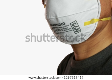Man wearing facial  N95 Filter face mask,  Ecology, air pollution, Environmental ,dust and smoke welding protection with small Royalty-Free Stock Photo #1297315417