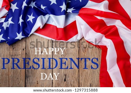 Happy Presidents' Day text on wooden with flag of the United States Border.