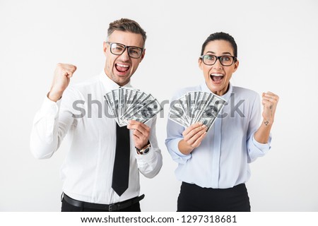 Image of young excited business colleagues couple isolated over white wall background holding money.