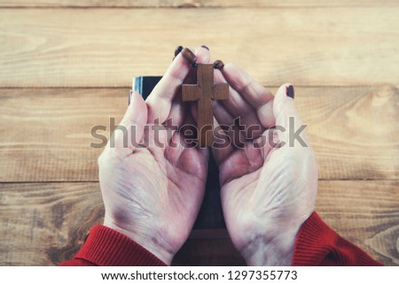 woman hand cross with book on table