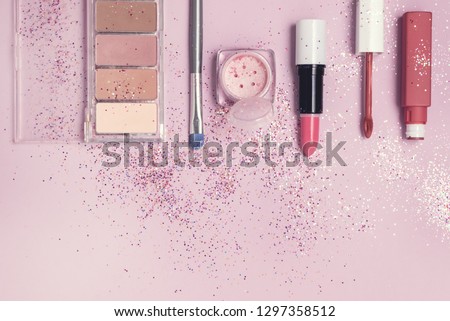 Sale Concept with Decorative Cosmetics on Pink Background Flat lay Top View Lipstick Eye Shadows Copy Space Toned