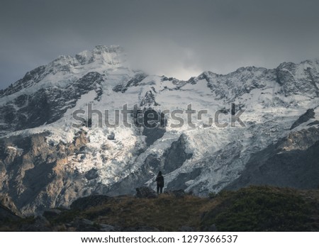 Hiker in front of snow cap mountain