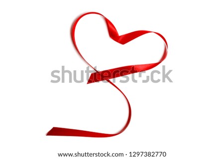 Closeup red satin ribbon or tape in heart shape isolated on white background. Concept Valentine's Day, wedding anniversary, honeymoon, newlyweds, lovers