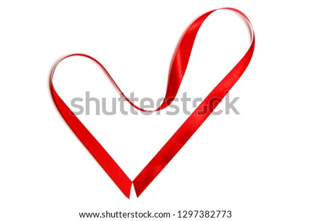 Closeup red satin ribbon or tape in heart shape isolated on white background. Concept Valentine's Day, wedding anniversary, honeymoon, newlyweds, lovers