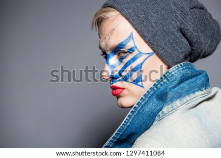  Young woman with blue star with stripes makeup on face wearing casual clothes