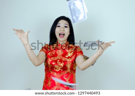 Asian woman wears a cheongsam red dress with throw money and feel excited, Isolated, Happy Chinese new year.