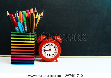 Back to school concept with school supplies , clock on blackboard background with copy space