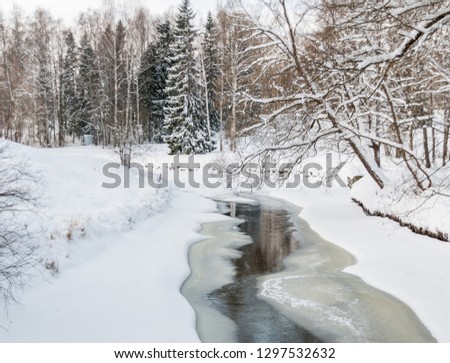 Flowing among the ice water. Non-freezing river in winter