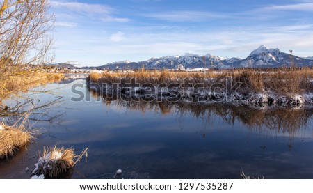 Winter Alps with snow and reflection in lake water