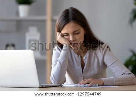 Bored at office work funny sleepy woman worker resting on hand sleeping at workplace, unmotivated lazy teen student feeling drowsy falling asleep near laptop, boring job and lack of sleep concept Royalty-Free Stock Photo #1297544749