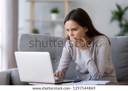 Shocked stressed young woman reading bad online news looking at broken laptop screen, confused teen girl in panic frustrated with stuck computer problem mistake virus, negative social media message Royalty-Free Stock Photo #1297544869
