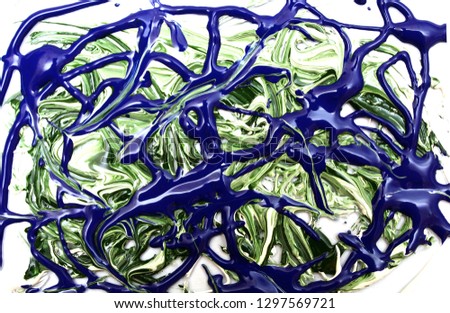 Abstract pattern of blue and green paint on a white background. A photo.