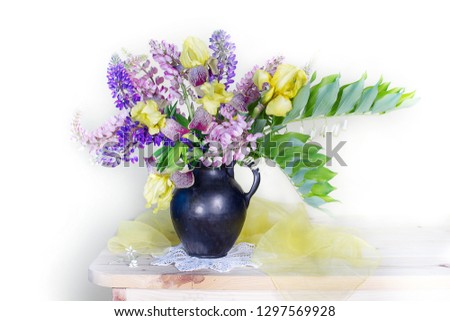 Still life with irises and lupines in a vase on the table