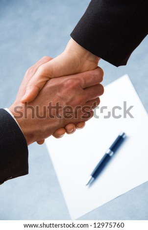 2 hands shaking with a blank contract and pen Royalty-Free Stock Photo #12975760