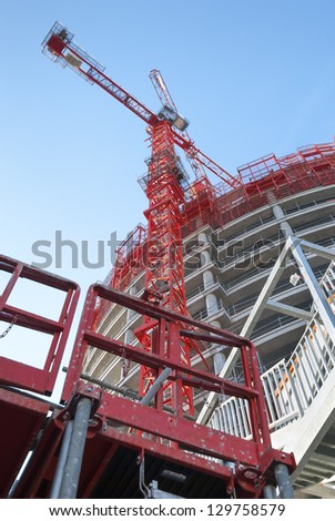 Business building under construction in Lyon, France with two cranes Royalty-Free Stock Photo #129758579