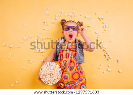 Cute girl eating popcorn