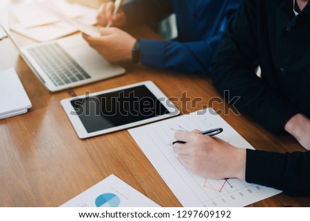 Image of teamwork business young businessmen using paper work and computer at meeting