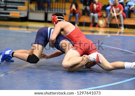 High School wrestlers competing at a wrestling meet.