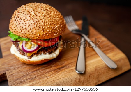 
Delicious fresh homemade burger on a cutting board