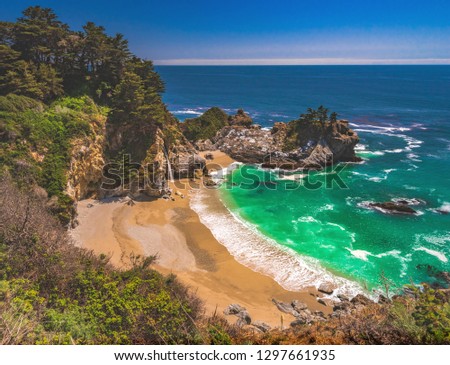 The iconic and beautiful cove setting of McWay Falls, part of Julia Pfeiffer Burns State Park off the Pacific Coast Highway 1 in Big Sur, central California Coast, United States.