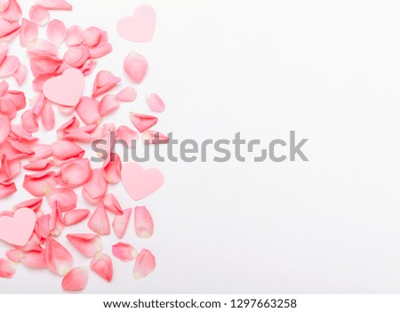 The composition of pink roses and hearts. Floral background for the holiday Women's Day, Valentine's, Mother's Day. Copy space, top view, flat lay