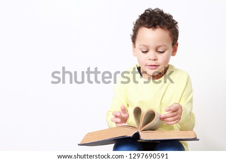 little boy with book stock photo