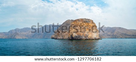 Sea tropical landscape with mountains and fjords, Oman. Vacation recreation holiday travel adventure concept.
