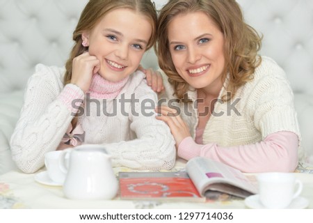 Mother and daughter drinking tea at home