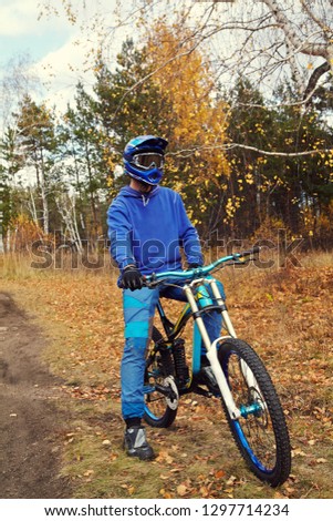 portrait of sporty man in a helmet with a mountain bike outdoor. extreme sport